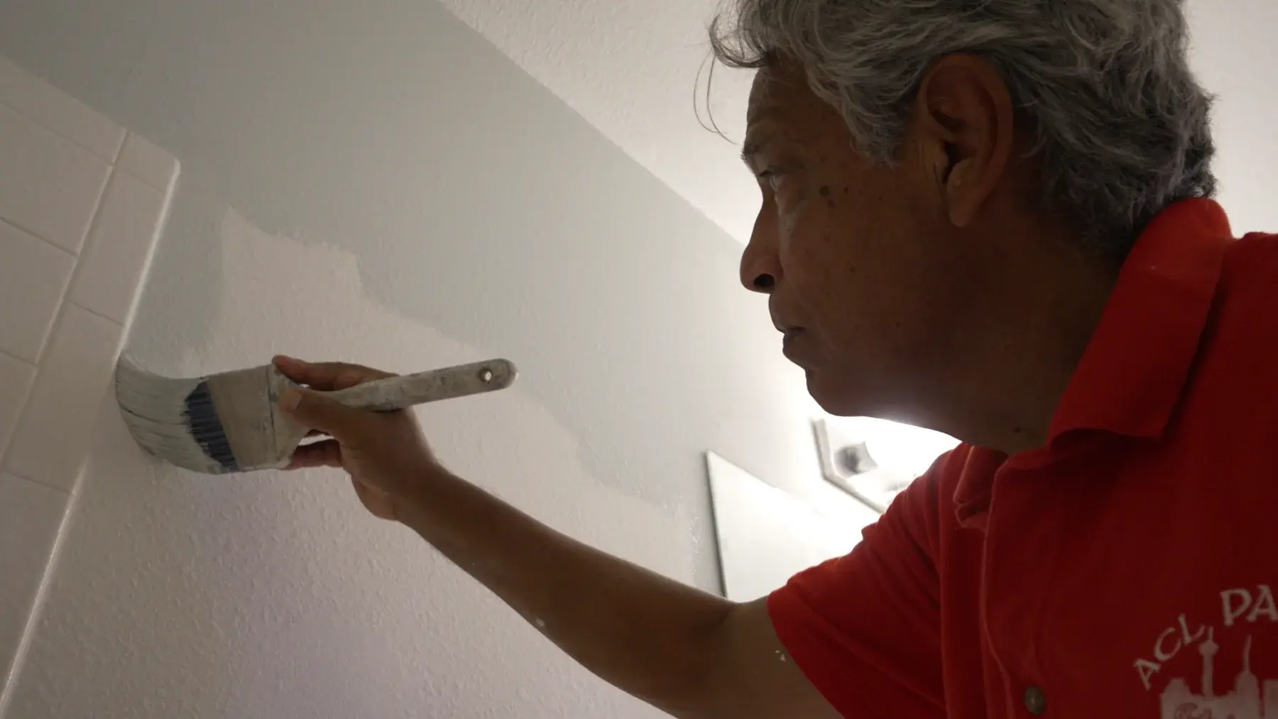 Michael Ramirez of A.C.L. Painting carefully painting an interior