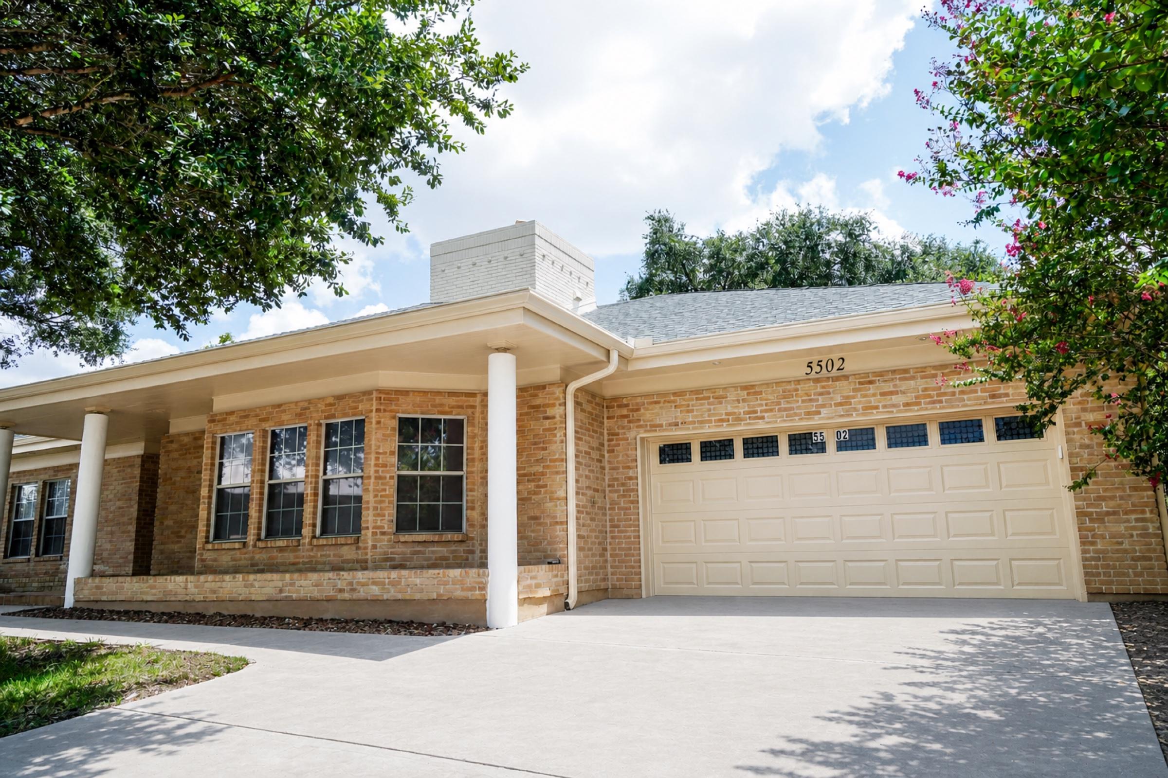 Completed exterior restoration showing the front of the San Antonio home