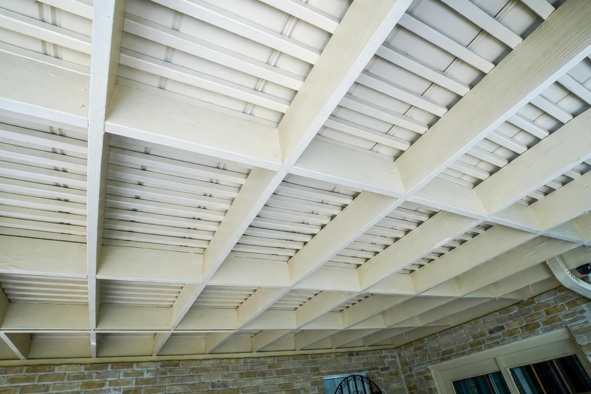 Finished painted beams and ceiling over a covered patio