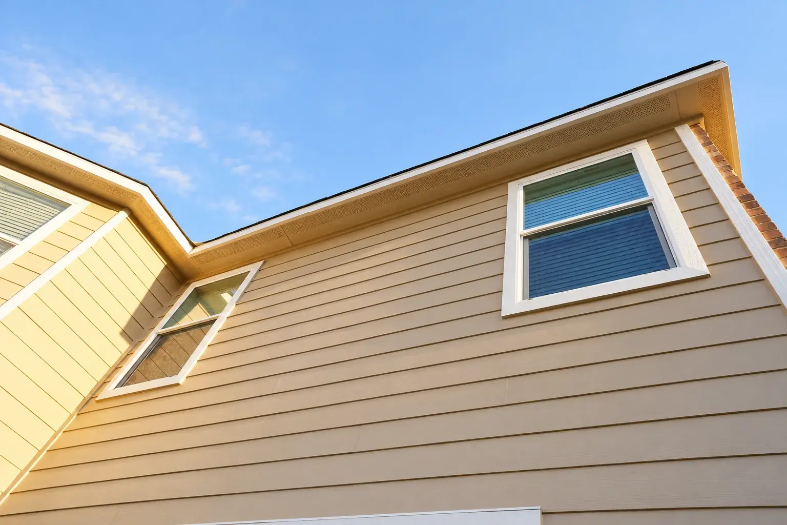 Finished upper rear siding, window trim, and eaves