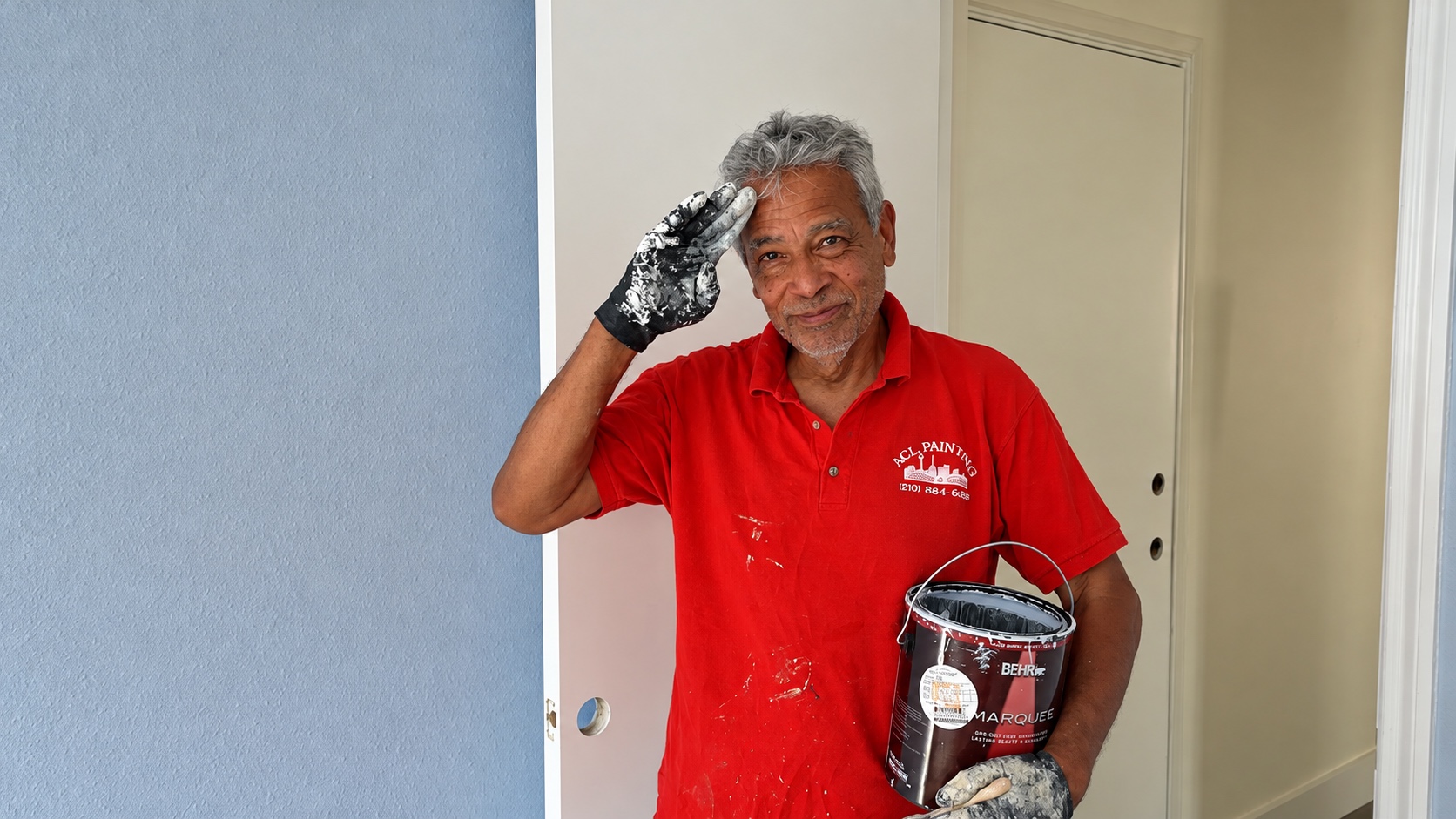 Michael Ramirez, owner of A.C.L. Painting, saluting on a job site